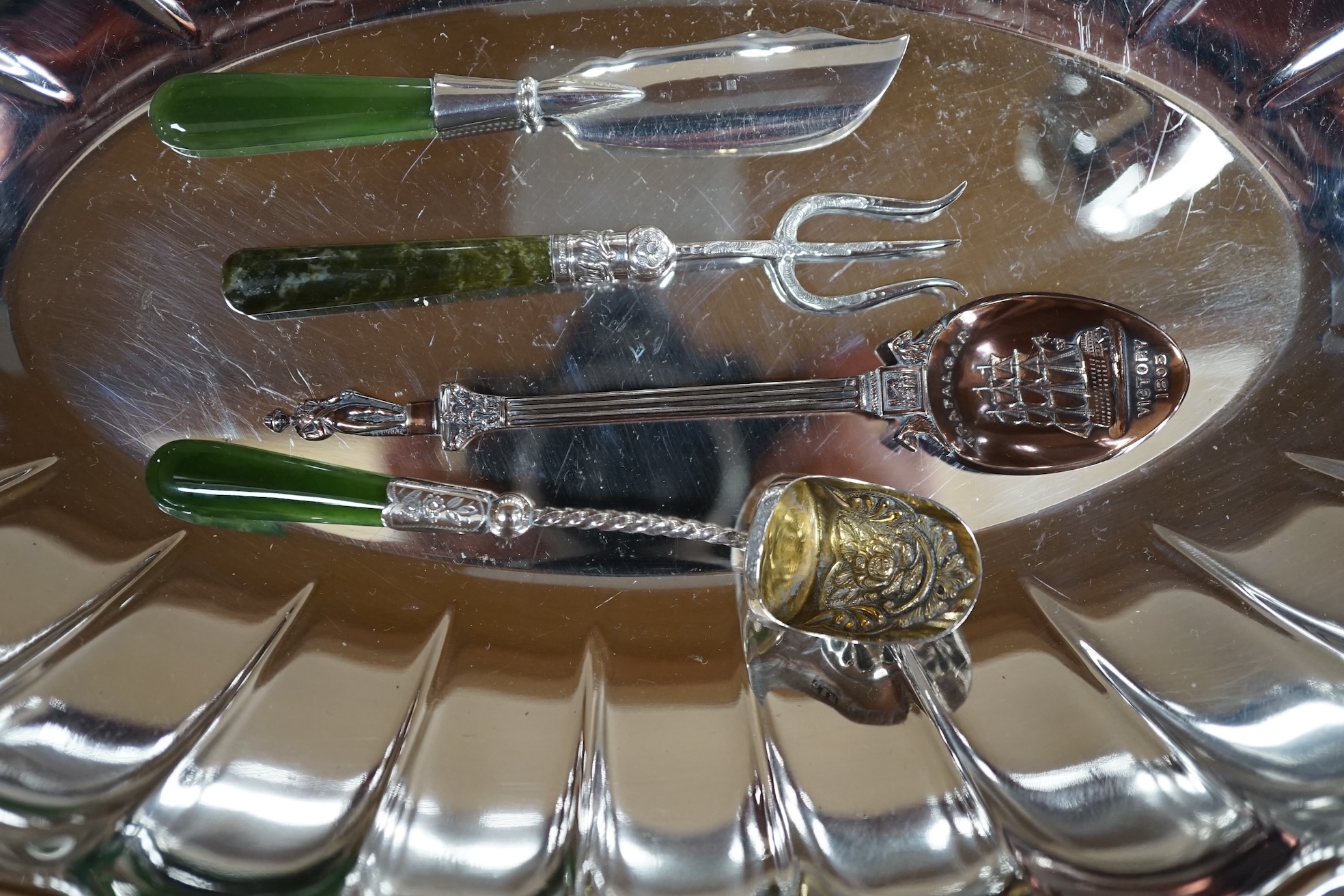 A George III silver toddy ladle with baleen handle, George Knight, London, 1818, a nephrite handled silver butter knife and sugar shovel and a small group of plated items, toddy ladle 35cm long. Condition - fair to good